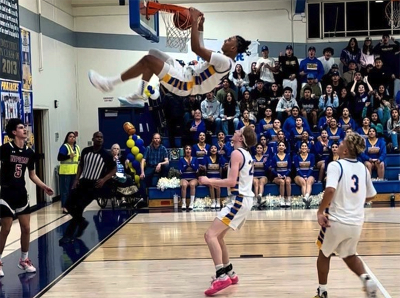 Basketball player dunking during a game